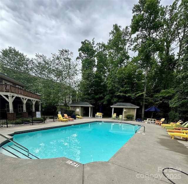 32 White Fox Dr, Fletcher, NC 28732 - community pool featuring a patio area, an outbuilding, and view of scattered trees