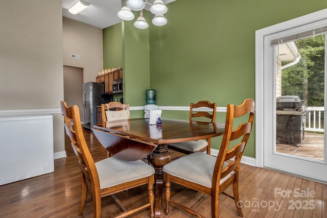 32 White Fox Dr, Fletcher, NC 28732 - dining room featuring a chandelier, wood-type flooring, baseboards, and a high ceiling