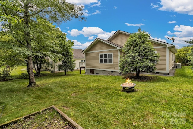 32 White Fox Dr, Fletcher, NC 28732 - rear view of house featuring a fire pit, a lawn, cooling unit, and crawl space