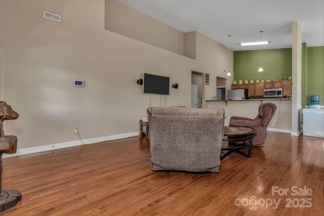 32 White Fox Dr, Fletcher, NC 28732 - living area featuring wood finished floors, a towering ceiling, and baseboards