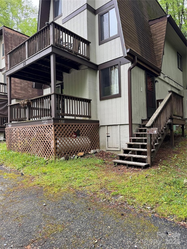 58 Creekside Dr Unit C, Banner Elk, NC 28604 - view of home's exterior with stairway, a balcony, roof with shingles, and a wooden deck