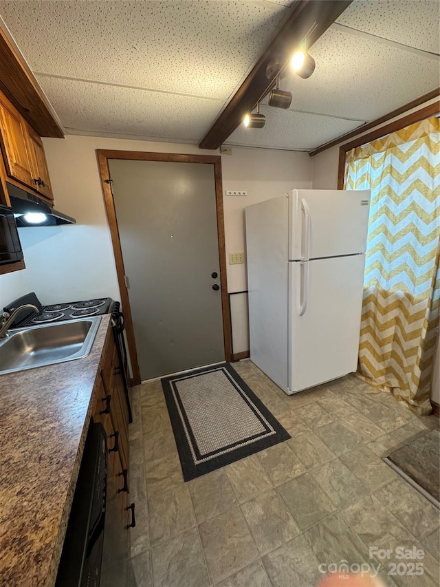58 Creekside Dr Unit C, Banner Elk, NC 28604 - kitchen with freestanding refrigerator, brown cabinetry, a sink, under cabinet range hood, and dark countertops