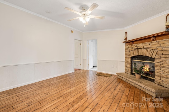 553 New Hope Rd, Rutherfordton, NC 28139 - unfurnished living room with a ceiling fan, wood finished floors, crown molding, a fireplace, and a wainscoted wall
