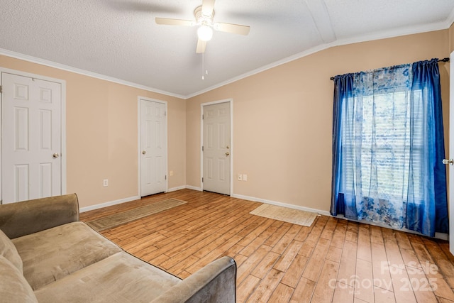 553 New Hope Rd, Rutherfordton, NC 28139 - unfurnished living room with light wood-style floors, ceiling fan, lofted ceiling, ornamental molding, and baseboards