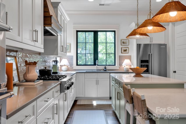 14105 Ryker Way, Davidson, NC 28036 - kitchen with appliances with stainless steel finishes, custom range hood, pendant lighting, decorative backsplash, and recessed lighting