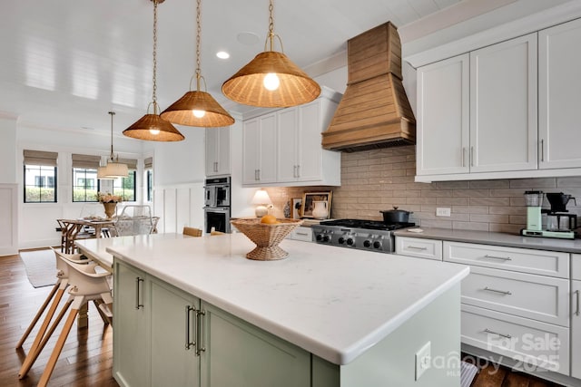 14105 Ryker Way, Davidson, NC 28036 - kitchen with custom exhaust hood, appliances with stainless steel finishes, decorative backsplash, a center island, and white cabinets