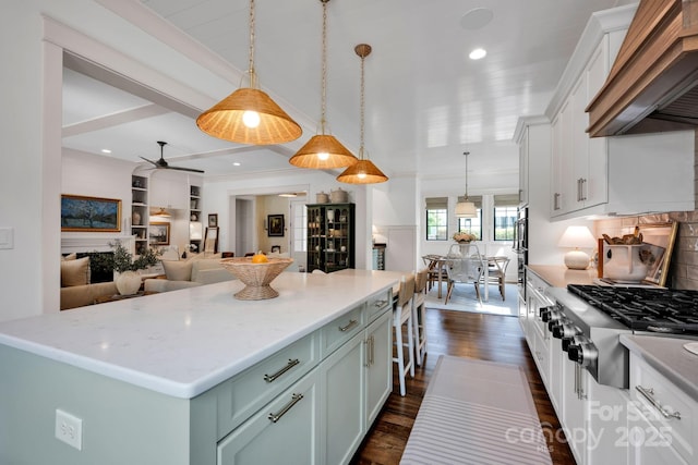 14105 Ryker Way, Davidson, NC 28036 - kitchen featuring custom exhaust hood, stainless steel gas cooktop, dark wood finished floors, backsplash, and hanging light fixtures