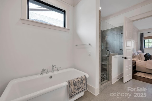 14105 Ryker Way, Davidson, NC 28036 - ensuite bathroom with a soaking tub, a shower stall, and tile patterned flooring