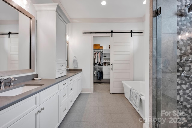 14105 Ryker Way, Davidson, NC 28036 - bathroom with double vanity, a shower stall, a freestanding bath, recessed lighting, and a spacious closet