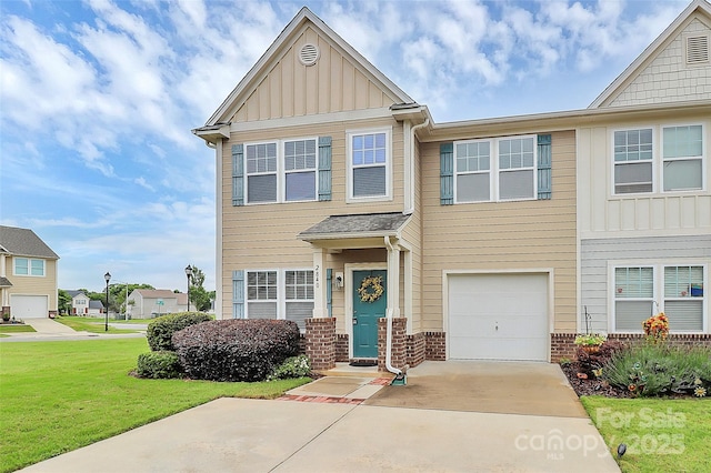 2840 Hopeton Ct, Monroe, NC 28110 - view of front of house with board and batten siding, a front lawn, brick siding, concrete driveway, and an attached garage