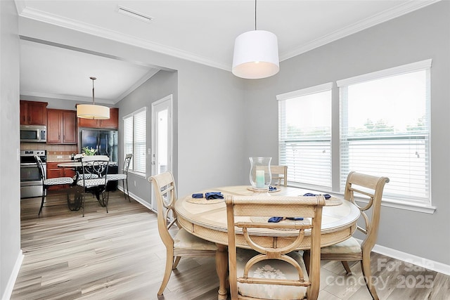 2840 Hopeton Ct, Monroe, NC 28110 - dining room with light wood-style floors, crown molding, and baseboards