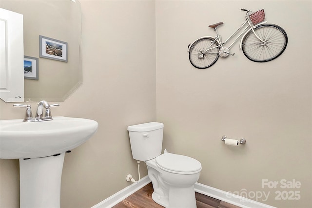 2840 Hopeton Ct, Monroe, NC 28110 - half bathroom featuring toilet, wood finished floors, and baseboards