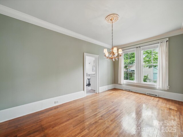 308 W Monroe St, Salisbury, NC 28144 - spare room with a chandelier, ornamental molding, light wood-style floors, and baseboards