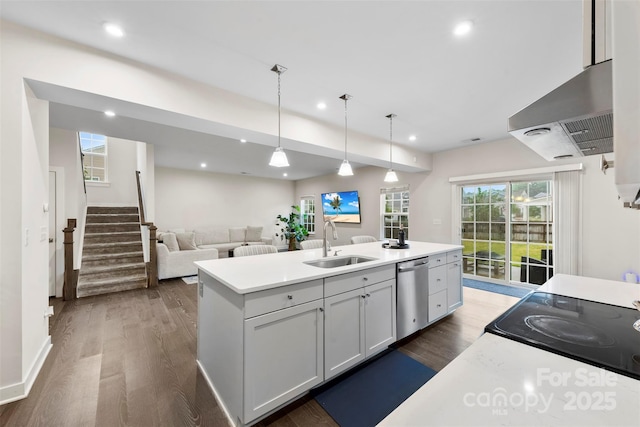 1022 Hinson Forest Rd, Monroe, NC 28110 - kitchen with stainless steel dishwasher, dark wood-style flooring, wall chimney range hood, recessed lighting, and light countertops