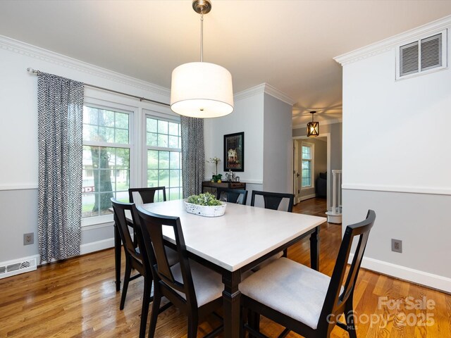 6941 Queensberry Dr, Charlotte, NC 28226 - dining room featuring wood finished floors, baseboards, and crown molding