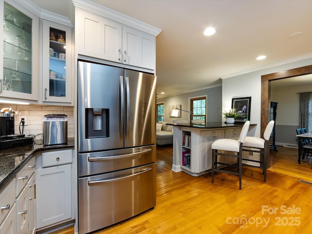 6941 Queensberry Dr, Charlotte, NC 28226 - kitchen featuring stainless steel refrigerator with ice dispenser, ornamental molding, light wood-style flooring, recessed lighting, and decorative backsplash
