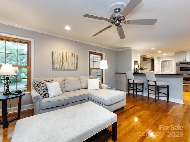 6941 Queensberry Dr, Charlotte, NC 28226 - living room featuring crown molding, light wood-style floors, ceiling fan, recessed lighting, and baseboards