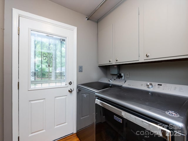 6941 Queensberry Dr, Charlotte, NC 28226 - laundry area with washer and dryer, cabinet space, and wood finished floors