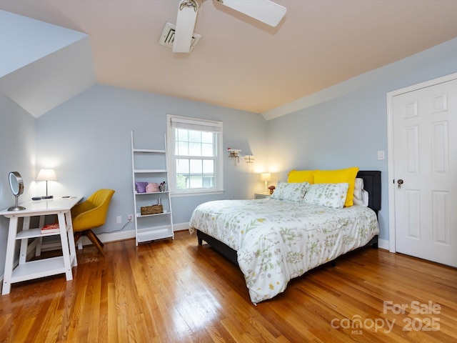 6941 Queensberry Dr, Charlotte, NC 28226 - bedroom featuring wood finished floors, vaulted ceiling, baseboards, and ceiling fan