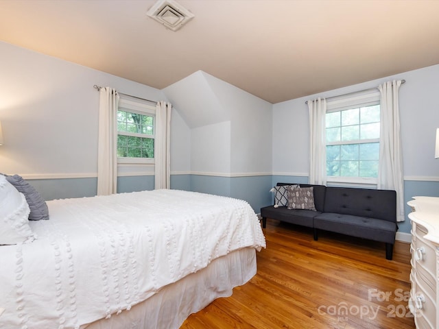 6941 Queensberry Dr, Charlotte, NC 28226 - bedroom with vaulted ceiling and light wood-type flooring