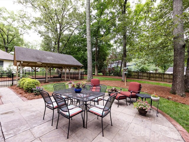6941 Queensberry Dr, Charlotte, NC 28226 - fenced backyard with a patio area, a gazebo, and outdoor dining space