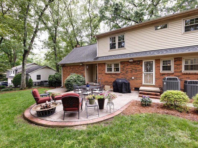 6941 Queensberry Dr, Charlotte, NC 28226 - back of house featuring cooling unit, brick siding, an outdoor fire pit, and a patio