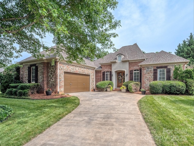 705 Woburn Abbey Dr, Fort Mill, SC 29715 - french provincial home featuring driveway, a garage, a front lawn, and stone siding