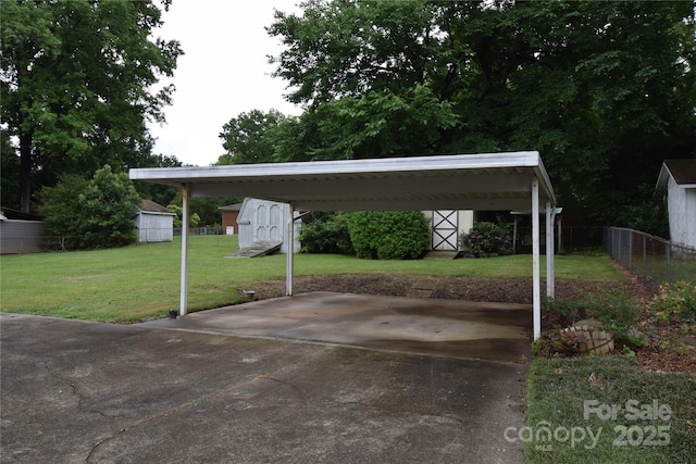 908 Ravendale Dr, Charlotte, NC 28216 - view of vehicle parking featuring a storage shed, a detached carport, and driveway