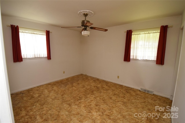 908 Ravendale Dr, Charlotte, NC 28216 - empty room with a ceiling fan, carpet flooring, and baseboards