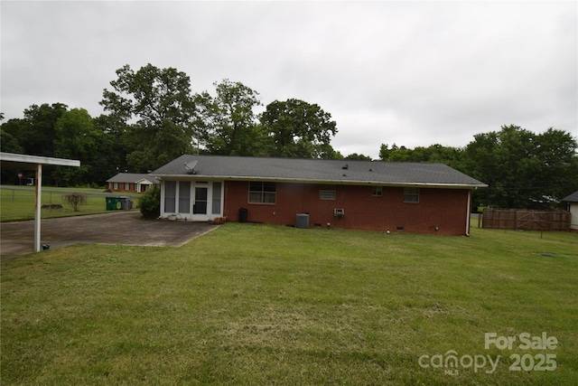 908 Ravendale Dr, Charlotte, NC 28216 - back of house featuring central AC, brick siding, and a patio