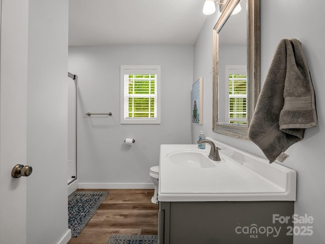 125 Woodland Cir, Rutherfordton, NC 28139 - full bath with baseboards, vanity, toilet, wood finished floors, and a shower with shower door