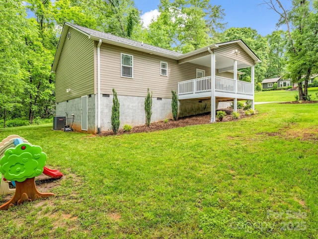 125 Woodland Cir, Rutherfordton, NC 28139 - back of property with a lawn, central air condition unit, and roof with shingles