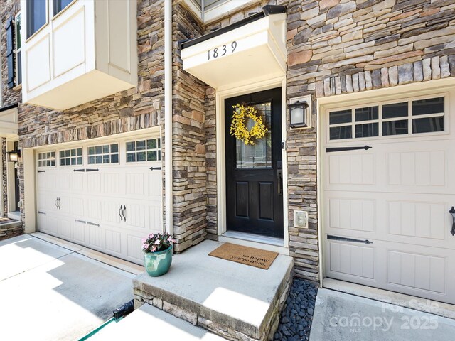 1839 Shumard Ln, Charlotte, NC 28205 - property entrance with stone siding and an attached garage