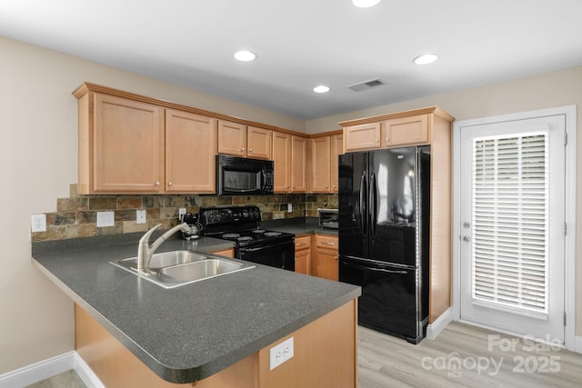 1907 Sandal Brook Rd, Fort Mill, SC 29707 - kitchen with black appliances, a sink, dark countertops, light brown cabinets, and a peninsula
