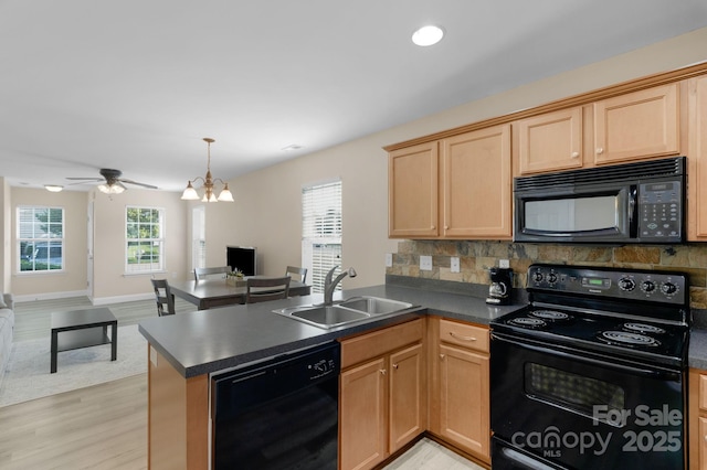 1907 Sandal Brook Rd, Fort Mill, SC 29707 - kitchen with black appliances, a sink, a peninsula, dark countertops, and decorative backsplash
