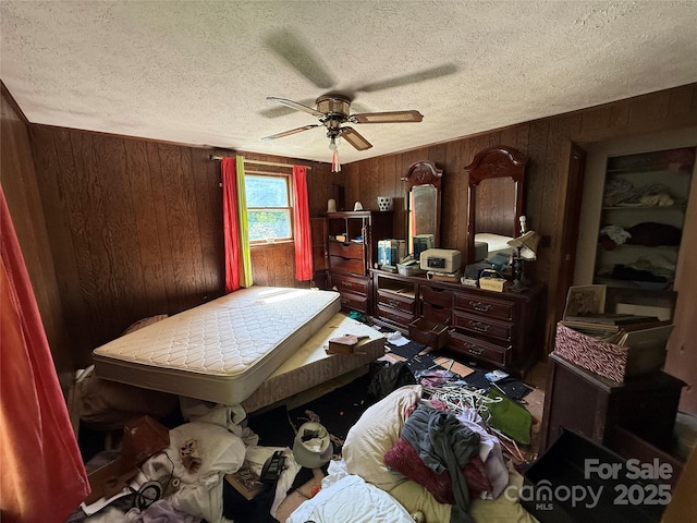 1278 Dry Pond Rd, Marshall, NC 28753 - bedroom with wood walls, a textured ceiling, and ceiling fan