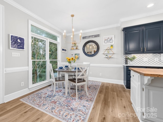 1115 Maremont Ct, Matthews, NC 28104 - dining space with ornamental molding, a chandelier, light wood-style flooring, and baseboards