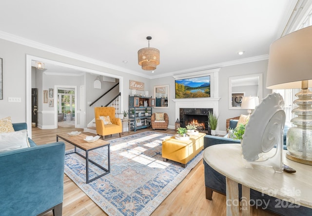1115 Maremont Ct, Matthews, NC 28104 - living area featuring a fireplace, crown molding, stairway, light wood-style flooring, and baseboards