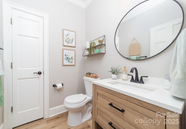 1115 Maremont Ct, Matthews, NC 28104 - half bathroom with vanity, crown molding, wood finished floors, toilet, and baseboards