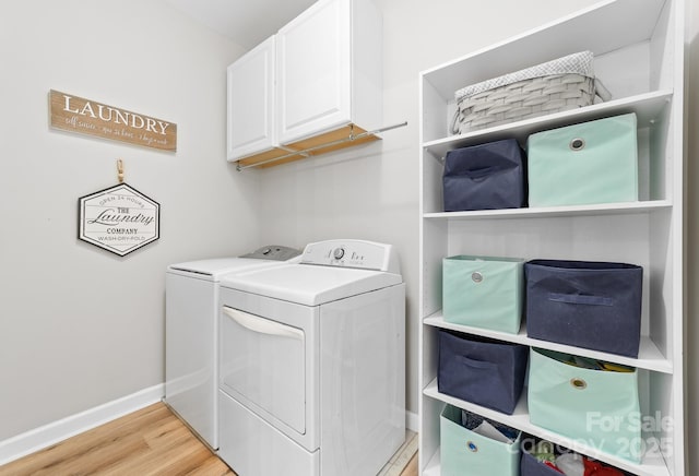 1115 Maremont Ct, Matthews, NC 28104 - laundry room featuring washing machine and clothes dryer, cabinet space, light wood finished floors, and baseboards