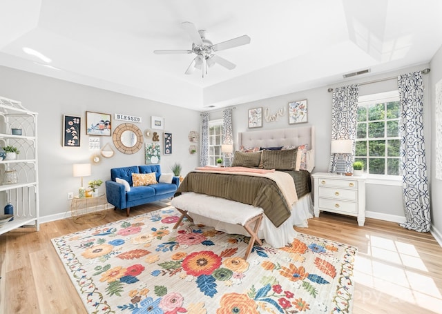 1115 Maremont Ct, Matthews, NC 28104 - bedroom with a raised ceiling, light wood-type flooring, baseboards, and ceiling fan