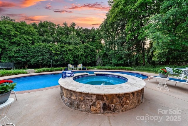 1115 Maremont Ct, Matthews, NC 28104 - view of swimming pool featuring a patio, a trampoline, and a pool with connected hot tub