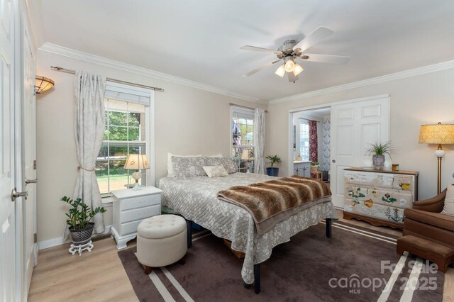 54 Donna Ln, Alexander, NC 28701 - bedroom featuring crown molding, multiple windows, light wood-type flooring, baseboards, and ceiling fan