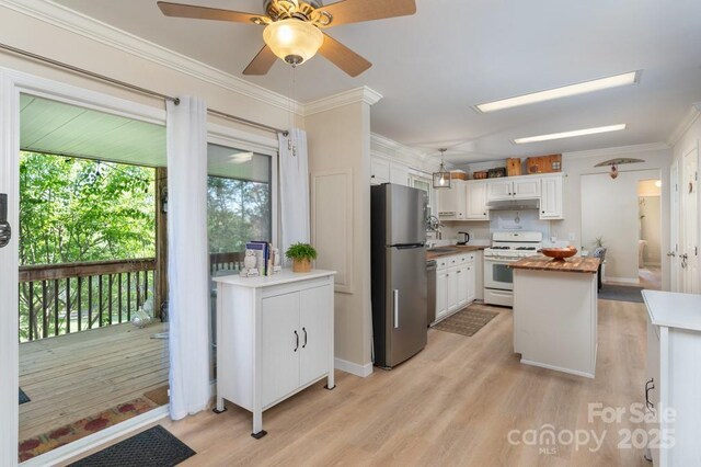 54 Donna Ln, Alexander, NC 28701 - kitchen with freestanding refrigerator, white gas range, light wood-style flooring, under cabinet range hood, and crown molding