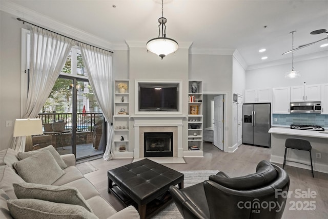 718 W Trade St Unit 105, Charlotte, NC 28202 - living room with ornamental molding, light wood-style flooring, recessed lighting, and a fireplace with flush hearth