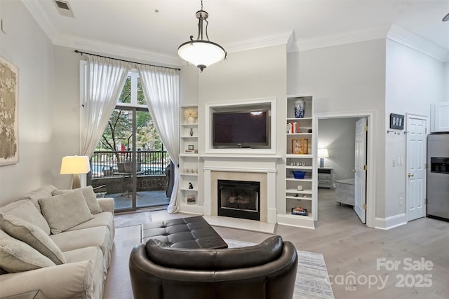 718 W Trade St Unit 105, Charlotte, NC 28202 - living room featuring ornamental molding, light wood finished floors, a high end fireplace, and built in features