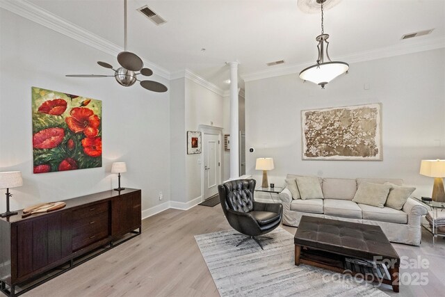 718 W Trade St Unit 105, Charlotte, NC 28202 - living room featuring ornamental molding, light wood-style floors, a ceiling fan, and ornate columns
