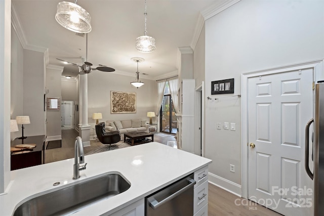 718 W Trade St Unit 105, Charlotte, NC 28202 - kitchen with crown molding, fridge, light wood finished floors, dishwasher, and decorative light fixtures