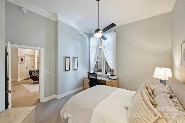 718 W Trade St Unit 105, Charlotte, NC 28202 - bedroom with crown molding, wood finished floors, a desk, ceiling fan, and a high ceiling