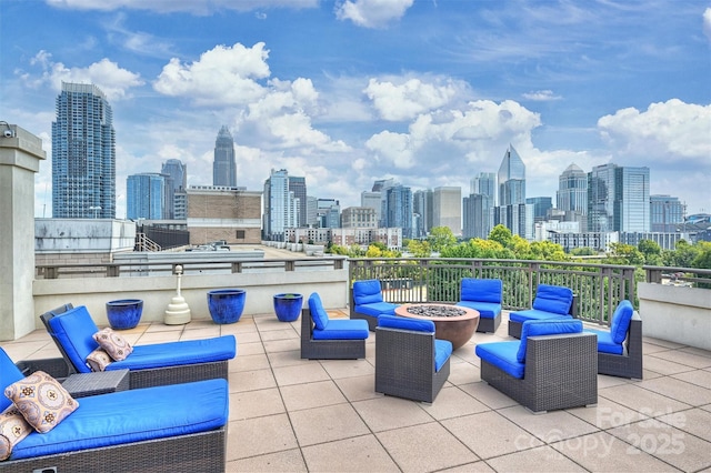 718 W Trade St Unit 105, Charlotte, NC 28202 - view of patio / terrace featuring a skyline view and an outdoor living space with a fire pit